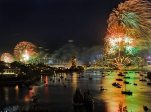 Wide view over Berrys bay of Sydney harbour on New Year night during NYE celebration fireworks highlighting CBD and Harbour bridge